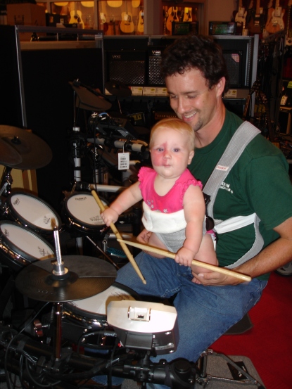 Addy in baby bjorn drumming